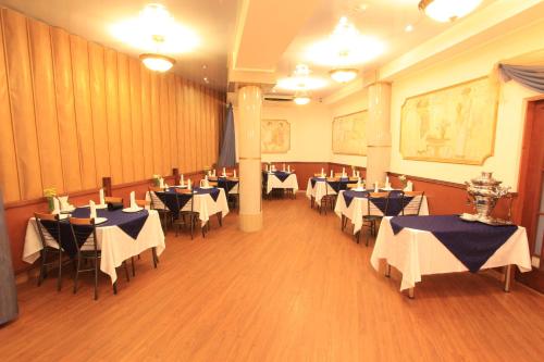 a dining room with tables and chairs in it at Fort Hotel in Yekaterinburg