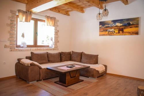 a living room with a couch and a table at Ville Uskoci in Žabljak