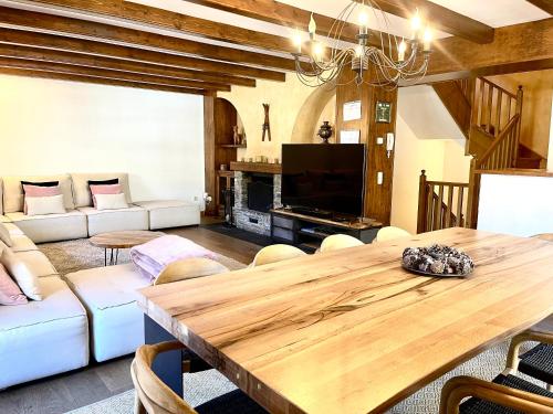 a living room with a wooden table and a couch at Xalet Kotki HUT1-005472 in Canillo