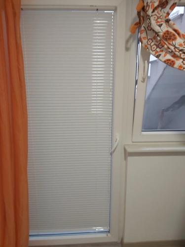 a window with blinds on it in a room at Lighthouse in Vodice