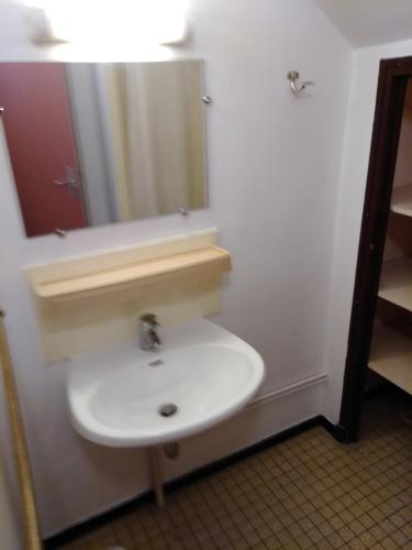 a bathroom with a white sink and a mirror at Cap Verb Guillestre in Guillestre