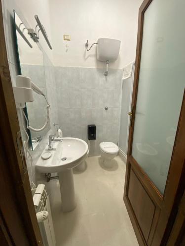 a bathroom with a sink and a toilet at IL PALAZZO - Luxury Home & Event in Cosenza