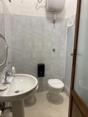 a bathroom with a white toilet and a sink at IL PALAZZO - Luxury Home & Event in Cosenza