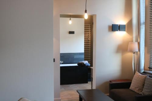 a living room with a couch and a bath tub at Peter House in Nivelles