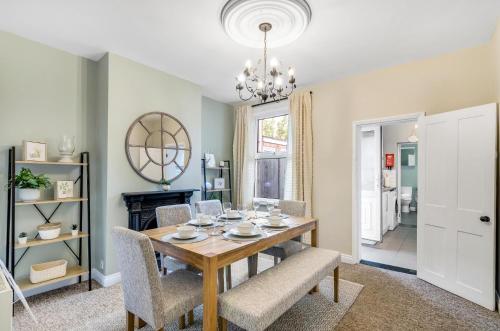 a dining room with a wooden table and chairs at 2BR Cosy Stay Near Cathedral Parking Workspace in Norwich