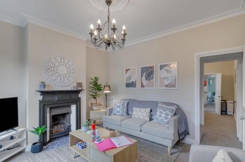a living room with a couch and a fireplace at 2BR Cosy Stay Near Cathedral Parking Workspace in Norwich
