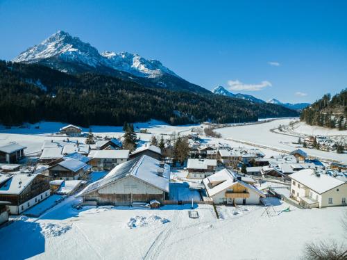 a village covered in snow with mountains in the background at Stöfflerhof in San Candido