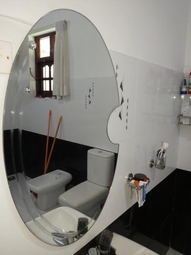 a bathroom with a toilet and a mirror at RAJASINGHE Guest in Kaduwela