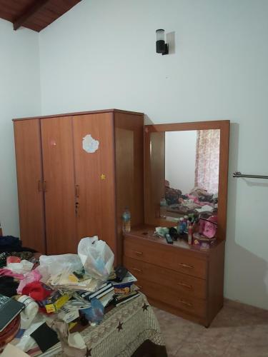 a messy room with a dresser and a mirror at RAJASINGHE Guest in Kaduwela