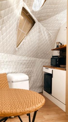 a kitchen with a ceiling that looks like a wave at Camping Alpujarras in Laroles