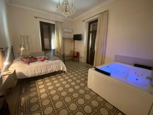 a bedroom with a bed and a tub at IL PALAZZO - Luxury Home & Event in Cosenza