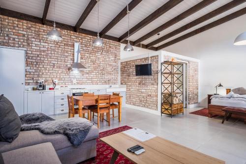 a living room with a couch and a table and a kitchen at Alte Villa Boutique Hotel in Lüderitz