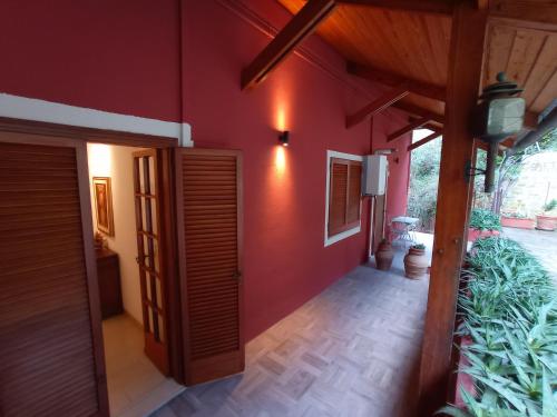 a hallway of a house with a red wall at ROMANTICA TOSCANA in Scarlino
