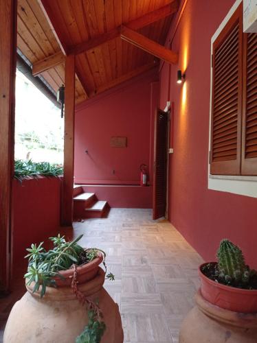 a hallway with red walls and potted plants at ROMANTICA TOSCANA in Scarlino