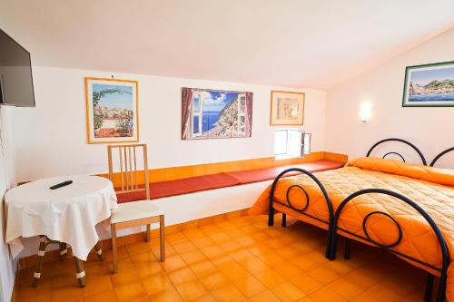 a bedroom with a bed and a table in it at Palazzo Della Marra in Ravello