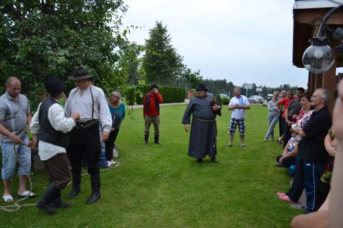 a group of people standing in the grass at Sodyba Tarp Liepų in Leliūnai