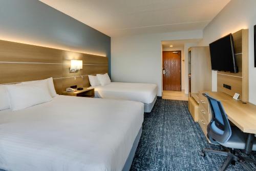 a hotel room with two beds and a desk at Parkshore Resort in Traverse City