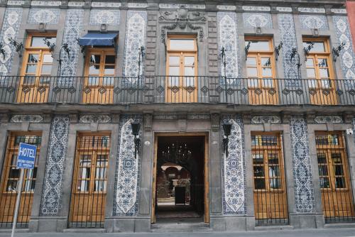 an ornate building with a door and a balcony at Casa Azulai Puebla Hotel Boutique in Puebla