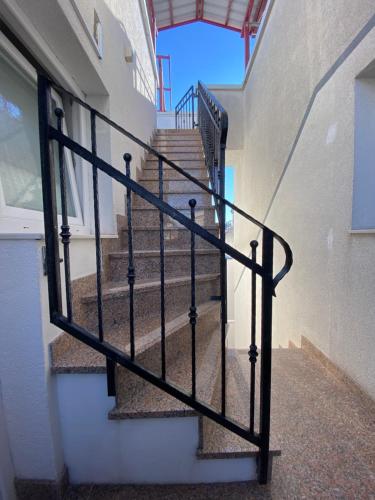 a stairway with a black metal railing in a building at Lighthouse in Vodice