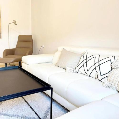 a living room with two white couches and a table at Friends and Family Leiwen in Leiwen