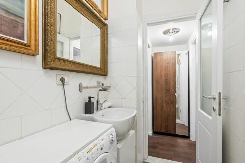 ein weißes Badezimmer mit einem Waschbecken und einem Spiegel in der Unterkunft Pop Corn House in Rom