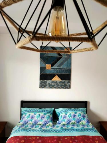 a chandelier hangs above a bed in a bedroom at Interno 7 in Barletta
