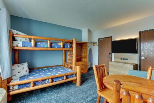 a bedroom with two bunk beds and a table at Parkshore Resort in Traverse City