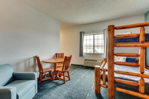 a room with a bunk bed and a table and chairs at Parkshore Resort in Traverse City