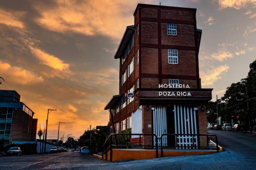a tall brick building with a sign on it at Hostería Poza Rica in Poza Rica de Hidalgo