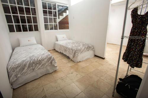 a bedroom with two beds in a room at Hostería Poza Rica in Poza Rica de Hidalgo