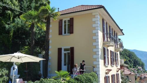 a man and a woman standing outside of a building at B&B Casa Forster in Cannero Riviera