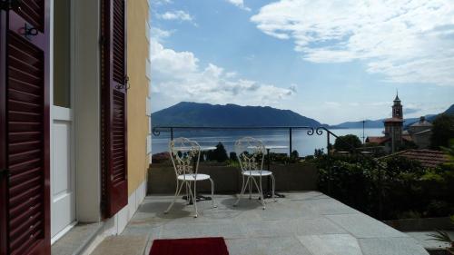 two chairs on a balcony with a view of the ocean at B&B Casa Forster in Cannero Riviera