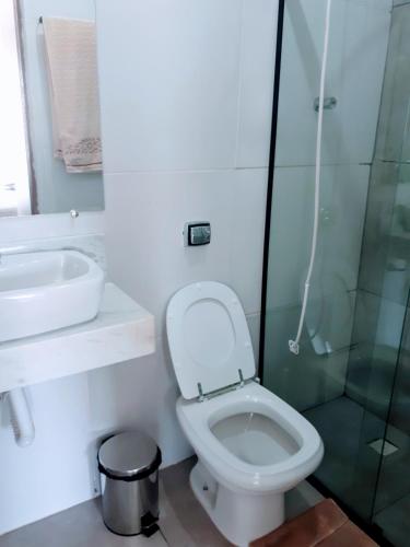 a bathroom with a toilet and a sink and a shower at Hospedaria São Benedito in Guararema