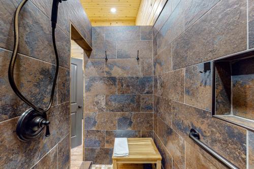a bathroom with a shower with tiled walls at Cozy Bear Cabin #2 in Sautee Nacoochee