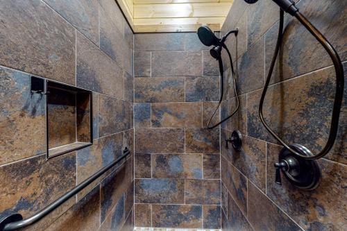 a shower with a shower head in a bathroom at Cozy Bear Cabin #2 in Sautee Nacoochee