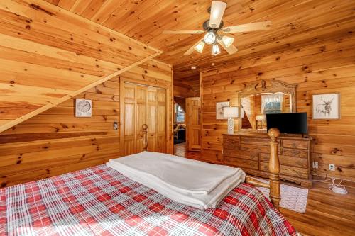 a bedroom with a bed and a ceiling fan at Boone Bounty in Boone