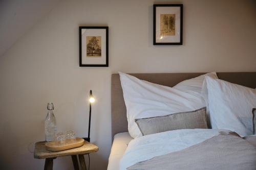 a bedroom with a bed and a table with a lamp at Aigen 13 - Dreiviertelhof im Waldviertel in Aigen
