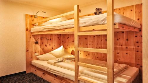 a bedroom with two bunk beds in a cabin at Apart Gabriele - Pure Alpin Style in Sankt Anton am Arlberg