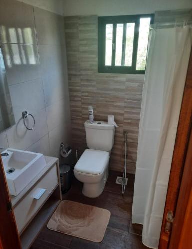 a bathroom with a white toilet and a sink at casas kiran y kanu con jacuzzi in Villa Serrana