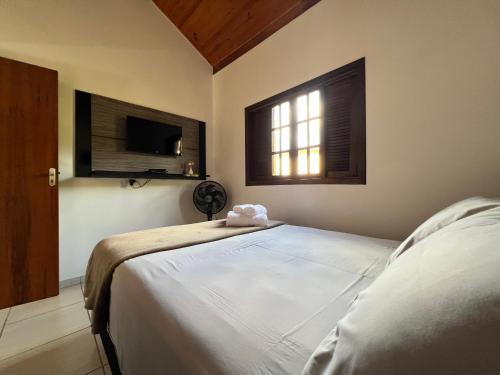 Кровать или кровати в номере Juquinha Chalé