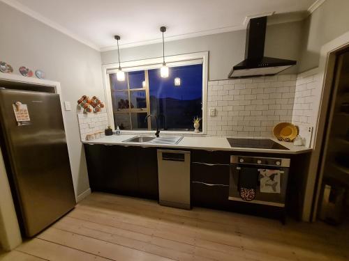 a kitchen with a sink and a stove and a window at Pura Vida by the Sea in Riverton