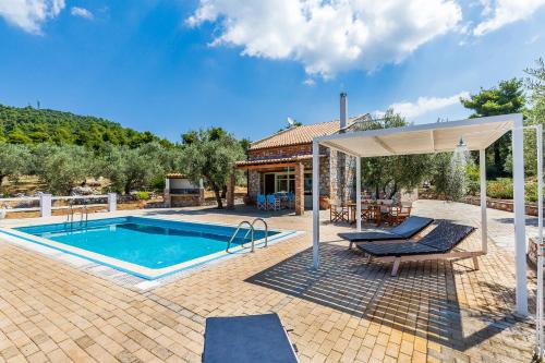 a house with a swimming pool and a pavilion at Villa Jasmine - Peaceful Sunset View Retreat in Skopelos Town
