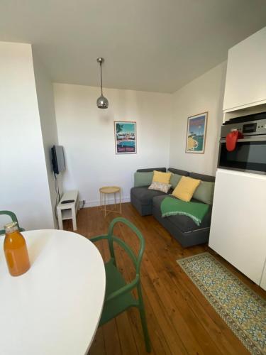 a living room with a couch and a table at Studio Duplex Bénodet in Bénodet