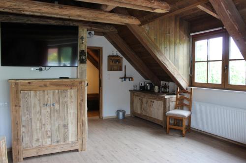 ein Wohnzimmer mit einem TV und einem Stuhl in der Unterkunft Tiefala's Eck in Stubenberg