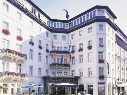 a large white building with a black roof at Radisson Blu Hotel Schwarzer Bock Wiesbaden in Wiesbaden