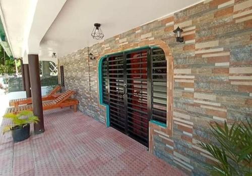 a patio with a brick wall with a wine cellar at La Frezza Beach House in Bayawan