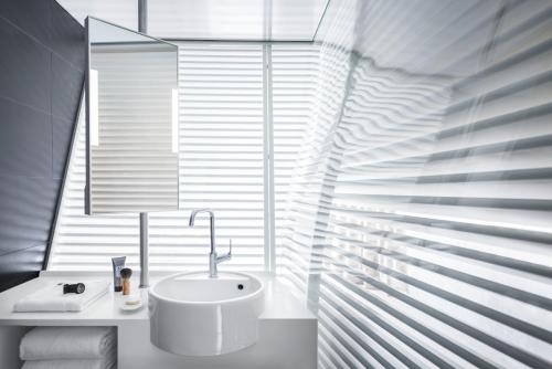 a bathroom with a sink in front of a window at OKKO Hotels Lyon Centre in Lyon