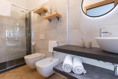 a bathroom with a sink and a toilet and a mirror at My Place In Verona in Verona