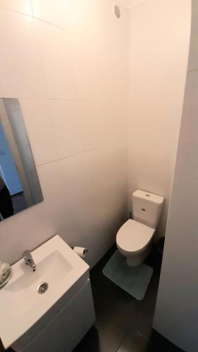 a bathroom with a white toilet and a sink at Casa 4P - House4People - Alojamento Local in Penacova