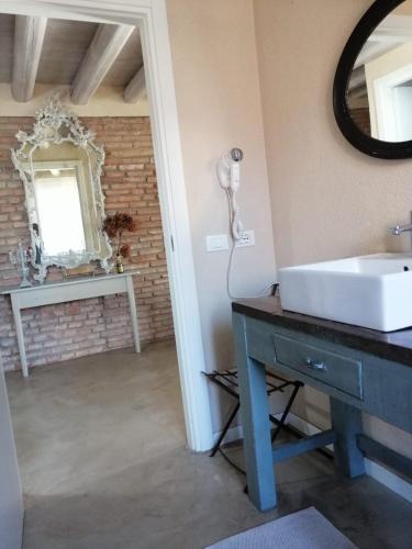 a bathroom with a sink and a mirror at Saxa Apartment in Verona